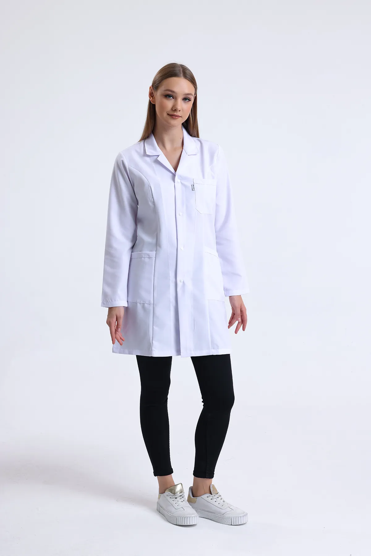 White lab coat produced by TB Uniform, worn full length